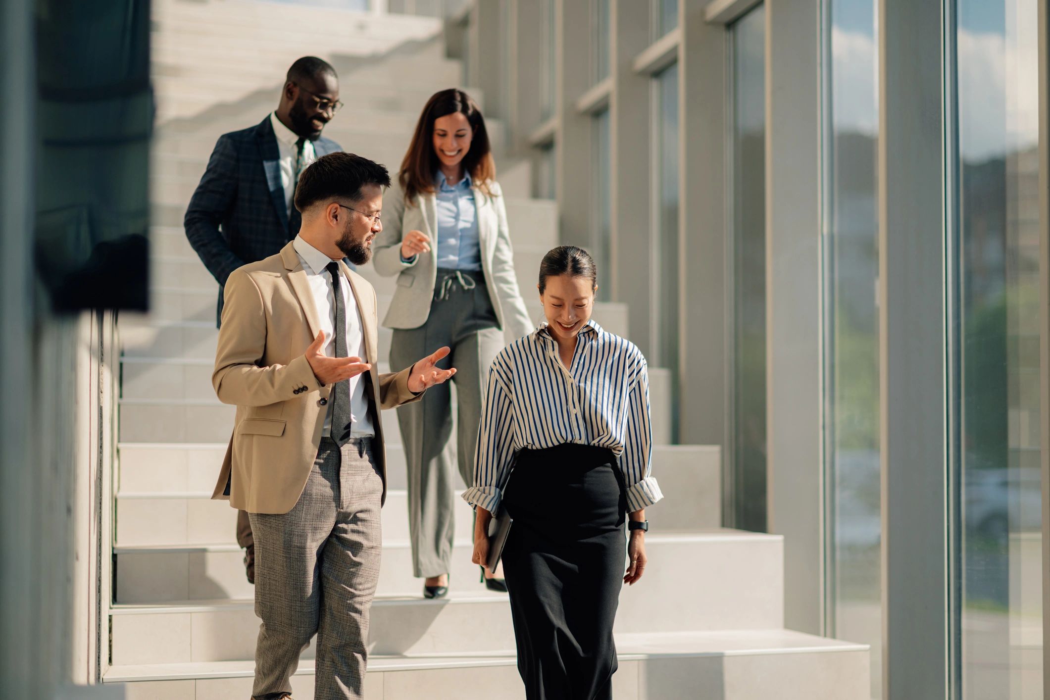 Professional team walking and discussing work in a modern office